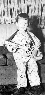 Picture of Eric Lawton at age 4 with Beatles guitar